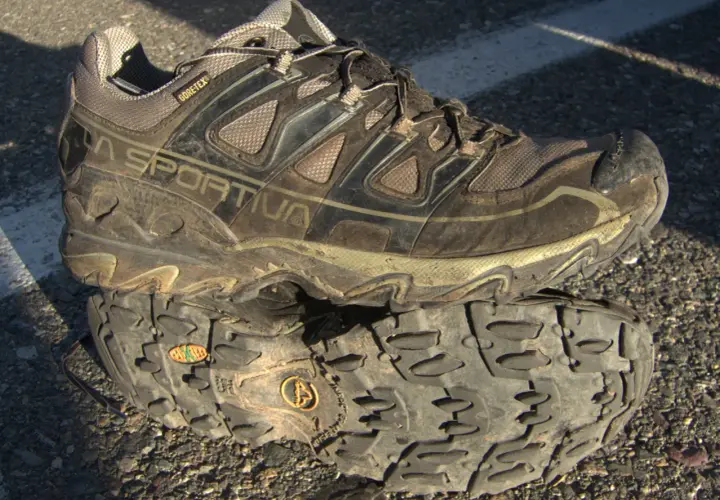 A muddy La Sportiva hiking shoe with "GORE-TEX" branding, indicating its waterproof and breathable meaning for shoes.