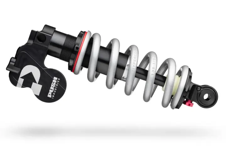 A PUSH Industries 11-6 rear shock absorber with a silver coil spring and black body, ready to tackle any trail.