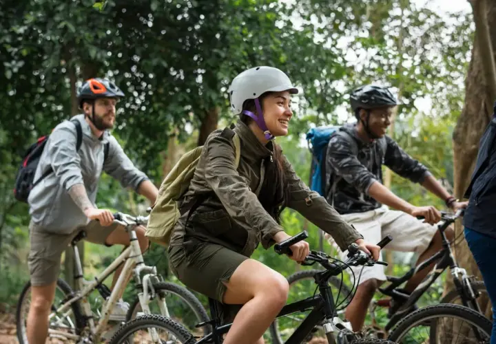 Friends enjoying a scenic ride through the woods, a perfect scene for France bicycle tours.