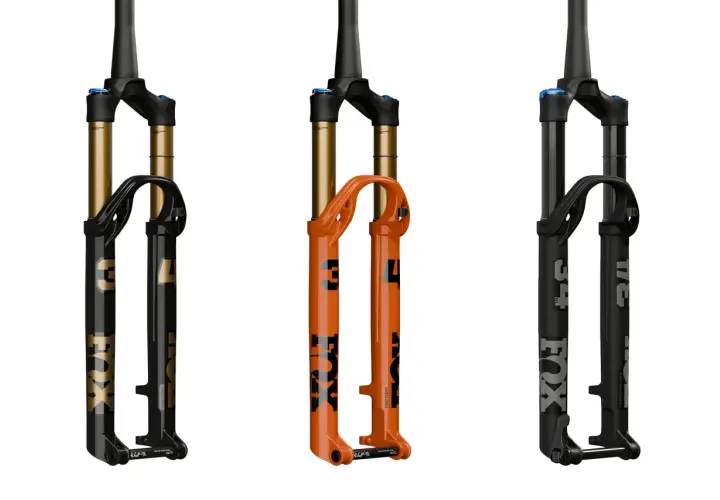 Three Fox Float SL suspension forks: one black with gold accents, one bright orange, and one matte black. Ready to float over any terrain.