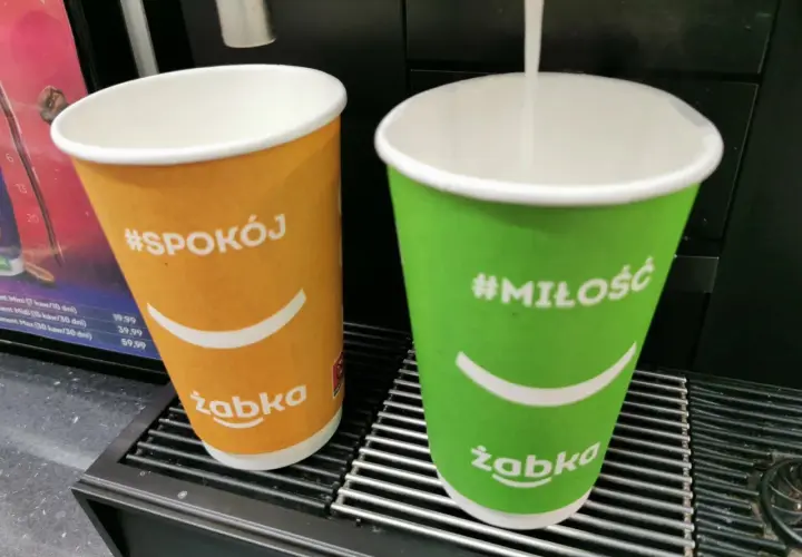 Dwie kawy z Żabki: pomarańczowa z napisem #Spokój i zielona z #Miłość. Duża kawa z Żabki ma 300 ml.