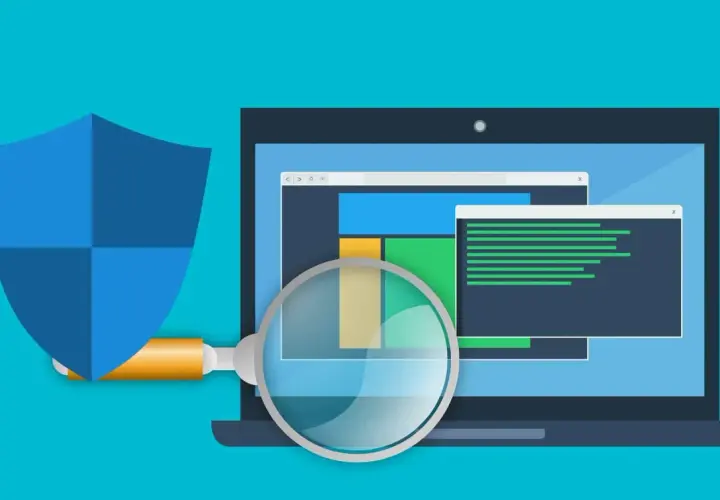 Bouclier bleu protégeant un ordinateur portable analysé par une loupe. Illustration sur la façon de se débarrasser du ransomware.