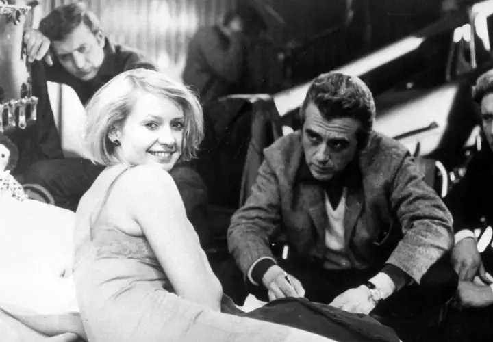 Uśmiechnięta Elżbieta Czyżewska z mężczyznami na planie filmowym. Choć nie widać dzieci, jej spojrzenie sugeruje radość i nadzieję.