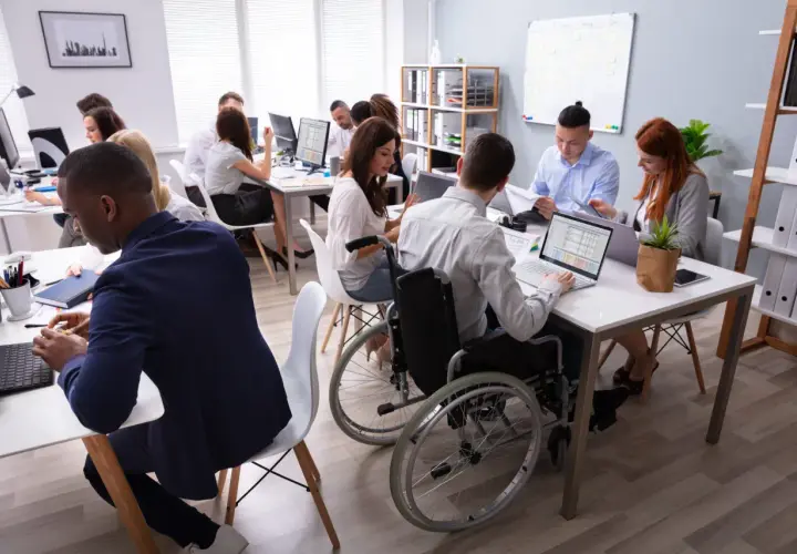 A diverse team collaborates in a modern office, showcasing the evolution of diversity and inclusion in the workplace.