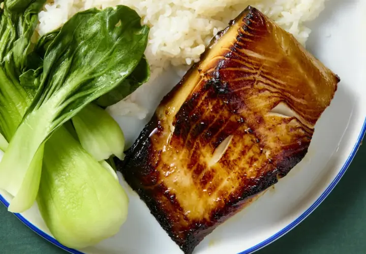 A perfectly seared miso cod recipe served with fluffy white rice and vibrant green bok choy.