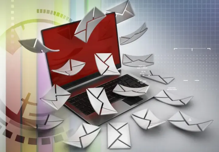 Un portátil rodeado de sobres digitales, como si se preguntara qué es Poe y cómo gestionar tantos correos.