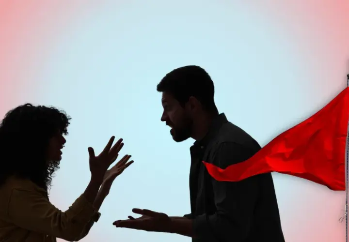 Coppia in silhouette che litiga, con una bandiera rossa che sventola, simbolo di un avvertimento.