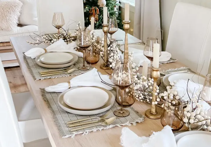 Elegant Christmas tablescapes featuring gold accents, white berry branches, and amber glassware.