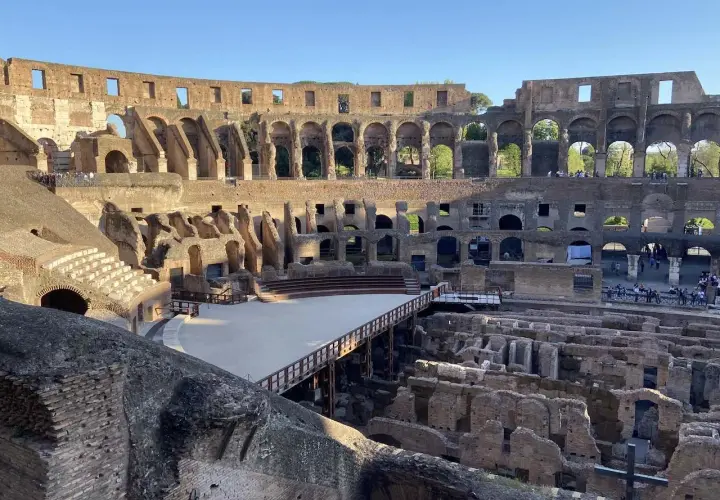 Intérieur du Colisée, vestiges de l'arène et des gradins. Un pont en bois traverse l'espace. Vérifiez l'horaire du Colisée pour votre visite.