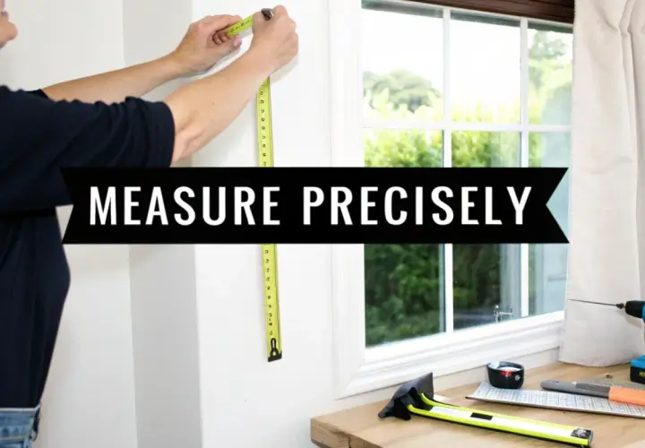 A person measures a window frame, demonstrating how to measure for pinch pleat curtains. Tools are laid out on a wooden surface.