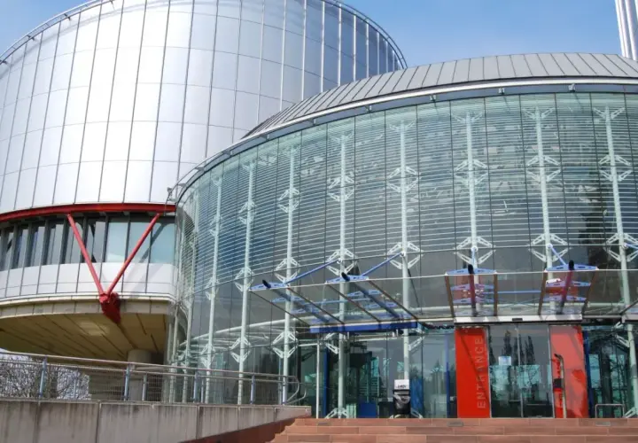 Nowoczesny budynek z przeszklonym wejściem i metalową fasadą. Tu zapadają ważne decyzje, tworząc precedens dla przyszłych pokoleń.