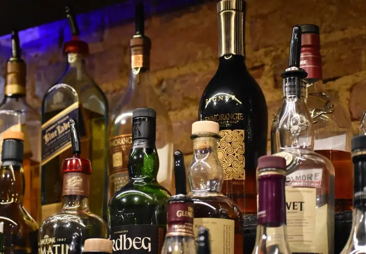Butelki whisky na półce. Pionowe przechowywanie zapobiega objawy wyschnięcia korka.