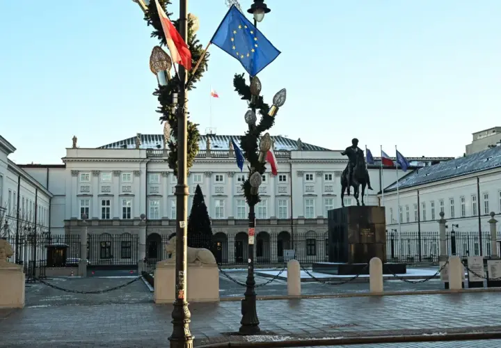 Pałac Prezydencki w Warszawie z pomnikiem konnym i flagami.