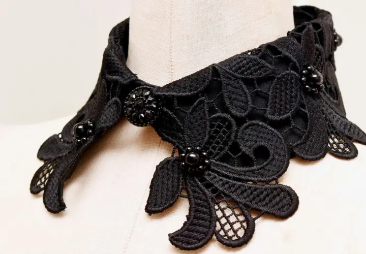 Intricate black lace collar with beaded embellishments, perfect for adding a touch of elegance. Learn how to make a lace collar with this detailed view.