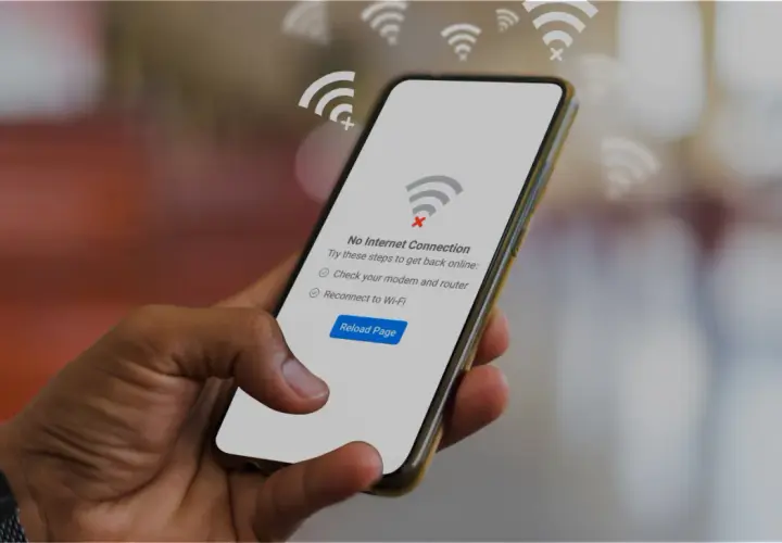 Dłoń trzyma smartfon z komunikatem "Brak połączenia z internetem". Czyżby awaria T-Mobile?