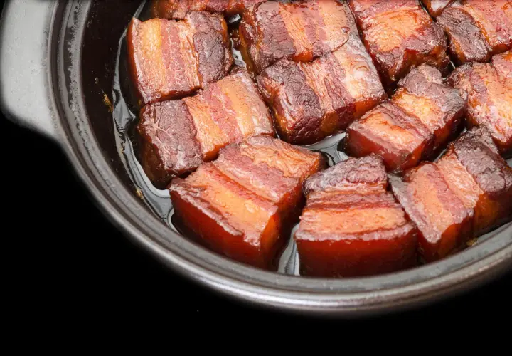 Close-up of succulent pork belly cubes, glistening in a rich sauce, ready for a delicious miso pork belly recipe.