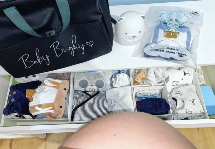 Borsa parto mamma: cosa mettere? Un cassetto organizzato con tutine, body e accessori per il neonato, pronto per l'arrivo.