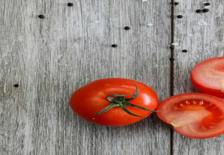 Frische Tomaten, reich an Lycopin, liegen auf rustikalem Holz. Die Lycopin-Wirkung ist bekannt für ihre antioxidativen Eigenschaften.