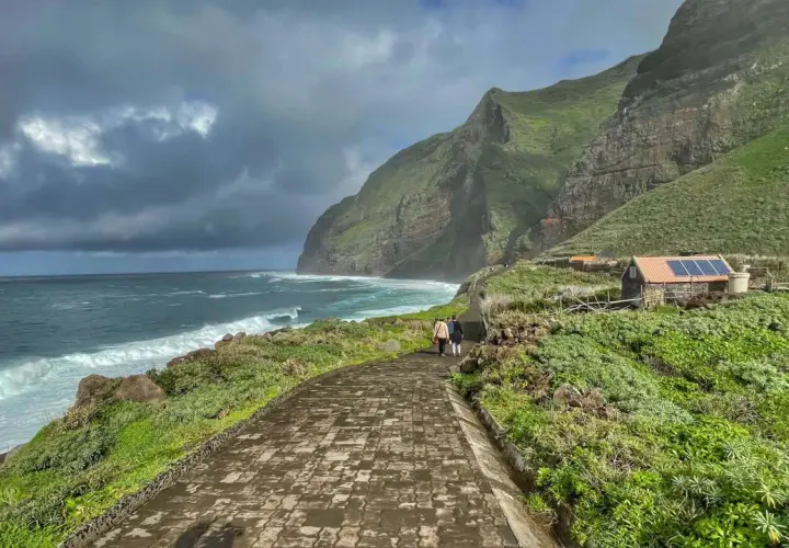 A scenic walk along the coast of Madeira, with dramatic cliffs and crashing waves. This view captures the essence of a week in Madeira.