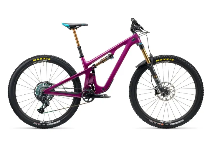 A vibrant purple Yeti SB140 mountain bike, ready for adventure, with gold suspension and colorful drivetrain.