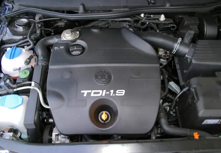 Silnik 1.9 TDI z widocznym logo Skoda. Widać elementy układu dolotowego i płyny eksploatacyjne.