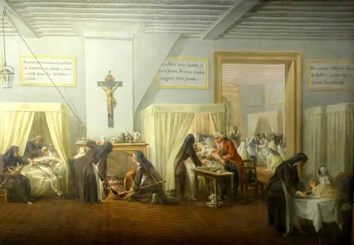 L'hôpital qui se fout de la charité : des religieuses soignent des malades, mais l'une d'elles semble négliger un patient. Une scène ironique.