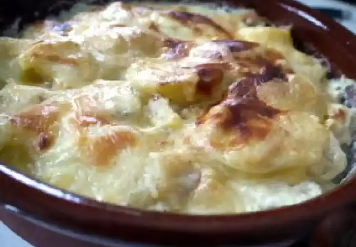 Pommes de terre, lardons et fromage raclette gratinés au four, un plat réconfortant et savoureux.