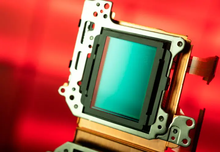 Sensor de cámara con superficie turquesa brillante. Los pequeños puntos que componen la imagen, que son los megapíxeles, capturan la luz para crear detalles.