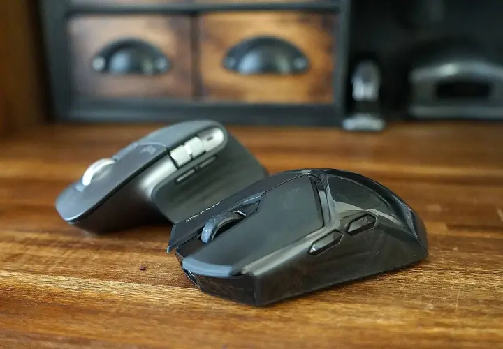 Dos ratones, periféricos de entrada esenciales, descansan sobre una mesa de madera.