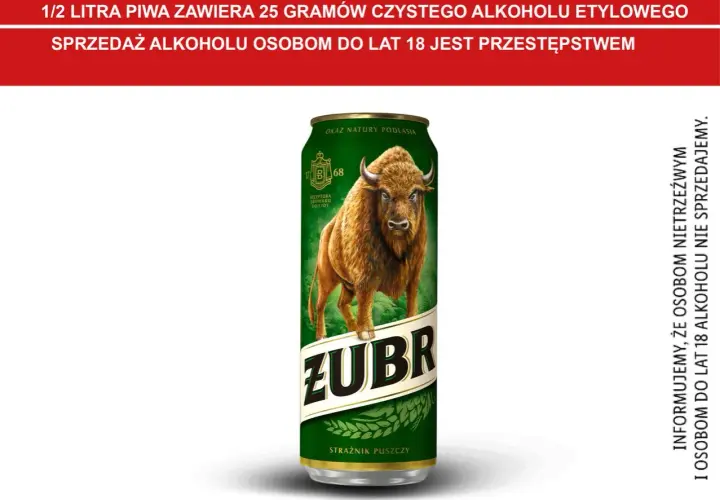 Puszczańskie piwo Żubr, z wizerunkiem żubra i napisem "Strażnik Puszczy". Informacja o zawartości alkoholu w piwie.