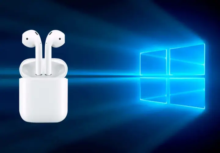 AirPods w etui na tle logo Windows. Czy da się podłączyć AirPods do laptopa? Tak, to możliwe!