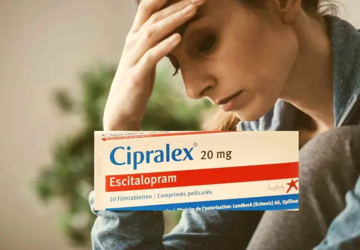 Donna con mal di testa tiene in mano una scatola di Cipralex, farmaco che serve per trattare depressione e ansia.