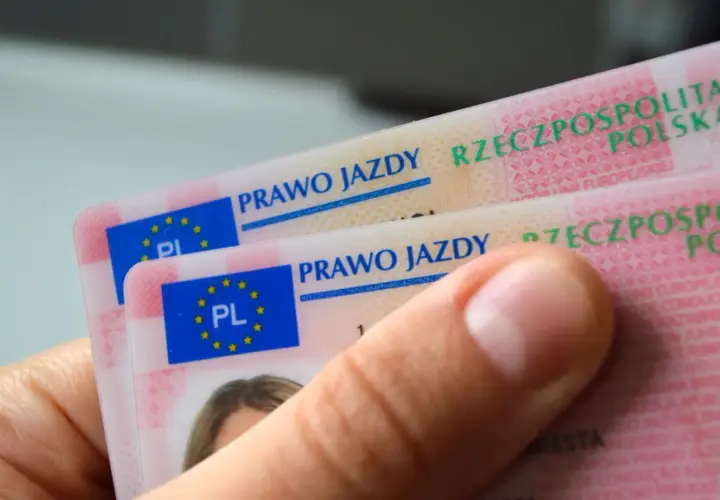 Dwie polskie karty prawa jazdy w dłoni. Dokumenty zawierają flagę UE i napis "Prawo jazdy Rzeczpospolita Polska".