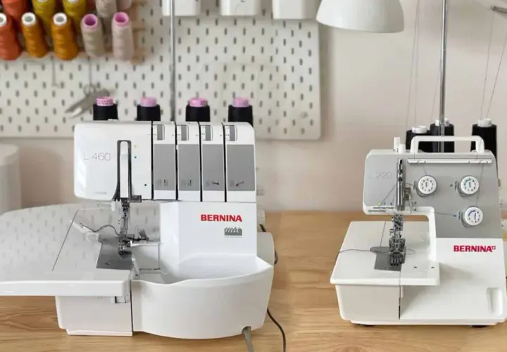 Two Bernina overlock machines, a serger vs overlock comparison, sit on a wooden table.