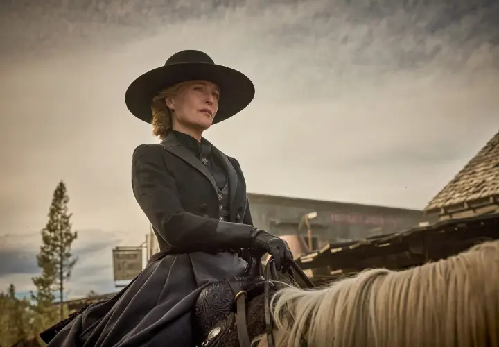 Gillian Anderson w westernowym stroju na koniu, przypominająca jej role w filmach i serialach.
