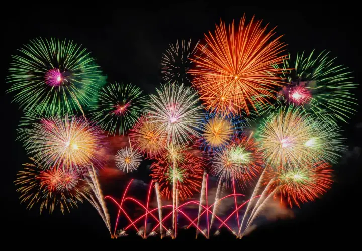 Ein farbenprächtiges Feuerwerk erhellt den Nachthimmel, wie es typisch für Silvester in Deutschland ist.