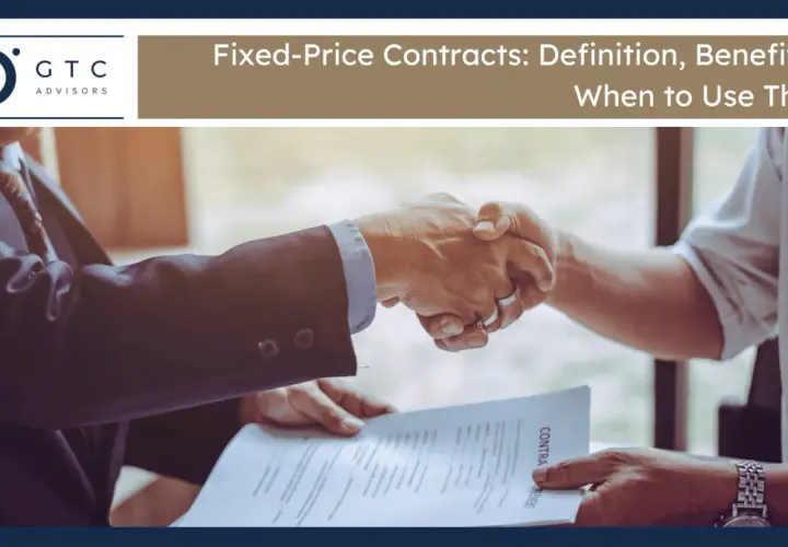 Two businessmen shake hands over a contract, signifying a firm fixed contract agreement.