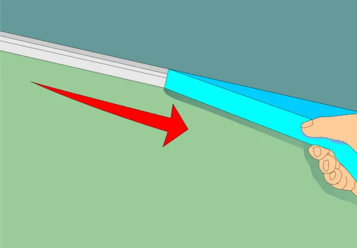 Applicazione di nastro adesivo blu per definire come fare bordo tra soffitto e parete. Freccia rossa indica la direzione.