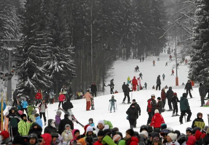 Tłumy narciarzy i snowboardzistów na stoku, przygotowujących się do szusowania. Wszyscy cieszą się zimową atmosferą, jakby to były ich wymarzone ferie 2027.