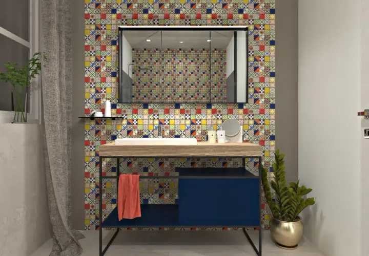 Un bagno moderno con un lavabo su un mobile blu scuro, incorniciato da un vivace **boxer mosaico** che riveste la parete.