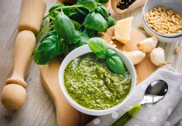 Un profumato pesto alla genovese, con basilico fresco, pinoli, aglio, parmigiano e pepe. Ingredienti pronti per un sapore autentico.