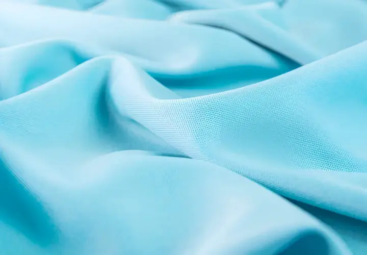 Soft, flowing turquoise lyocell fabric with subtle texture.