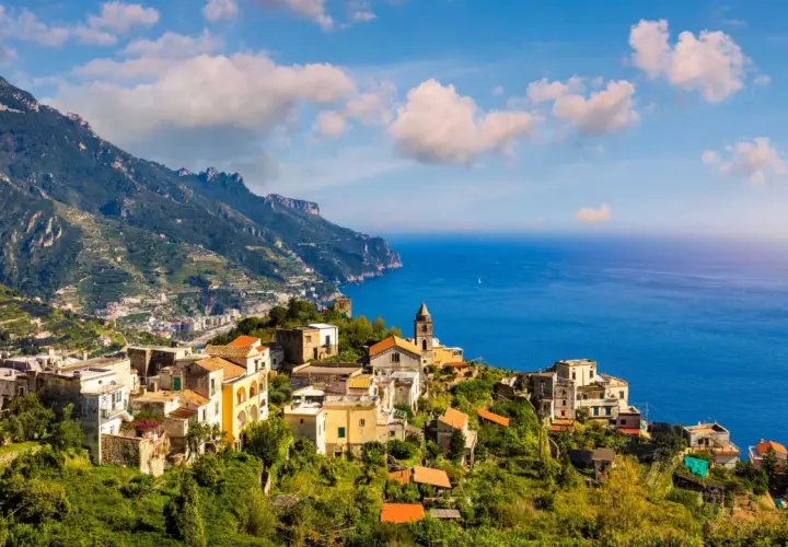 Scenic view of Ravello, Italy, perched on a cliff overlooking the sea. Planning how to get from Naples to Ravello? This picturesque town is worth the journey!