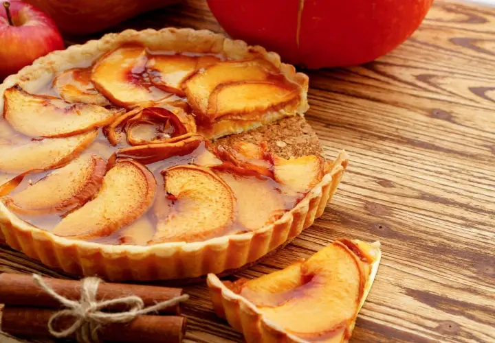 Deliziosa crostata con mele caramellate e cannella, un classico tra i dolci con mele, pronta per essere gustata.