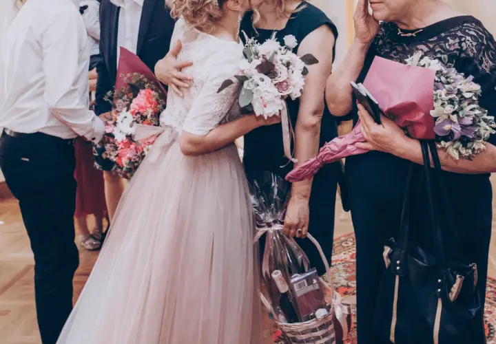 Wzruszający moment na weselu: piosenka dla rodziców, bukiety i kosz prezentowy.