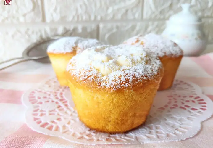 Tre muffin soffici, spolverati di zucchero a velo, perfetti per una ricetta muffin semplici e golosa.