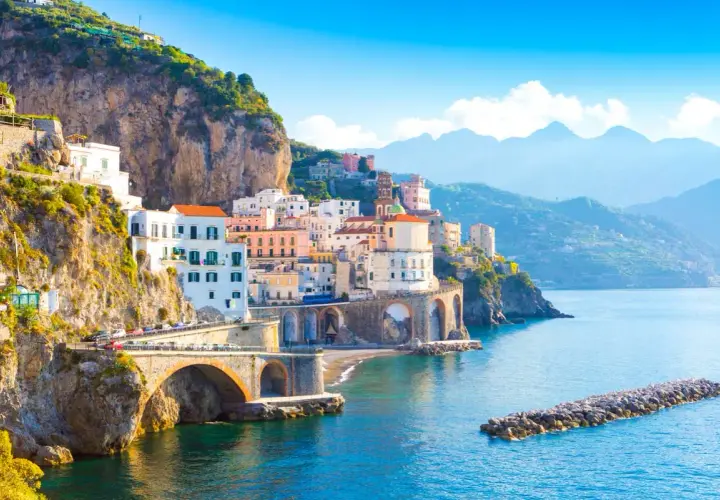 Colorful buildings cling to cliffs overlooking the sea. The Amalfi Coast is safe for exploring this picturesque Italian paradise.