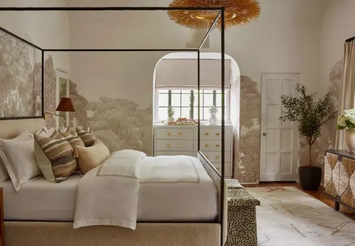 A serene bedroom featuring a canopy bed, botanical wallpaper, and a mix of natural textures, showcasing diverse bedroom styles.