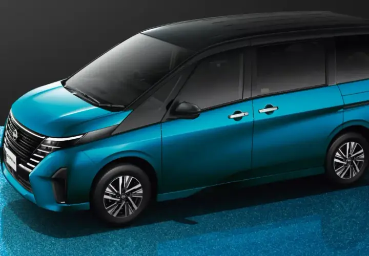 Elegancki, błękitny Nissan Serena z czarnym dachem prezentuje się nowocześnie na błyszczącym, niebieskim tle.