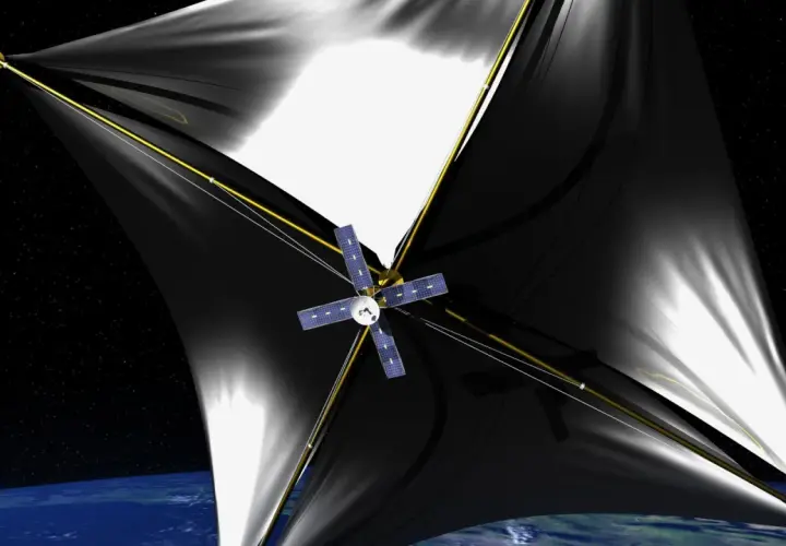 Statek kosmiczny z czarnymi żaglami, symbolizujący przełom w podróżach międzygwiezdnych, unosi się nad Ziemią. Breakthrough starshot.